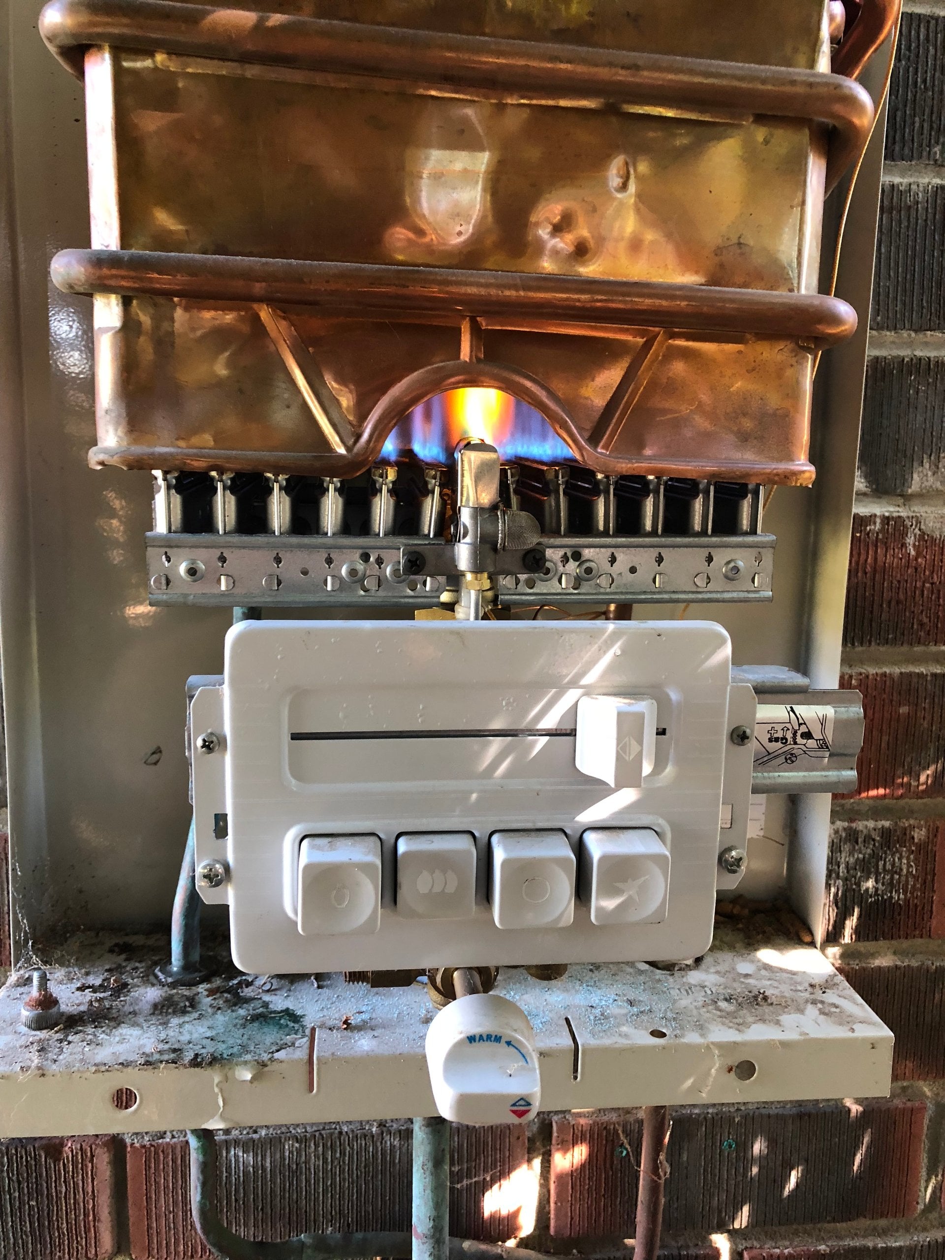 Copper gas pipework feeding the burner of a gas unit at a Perth home