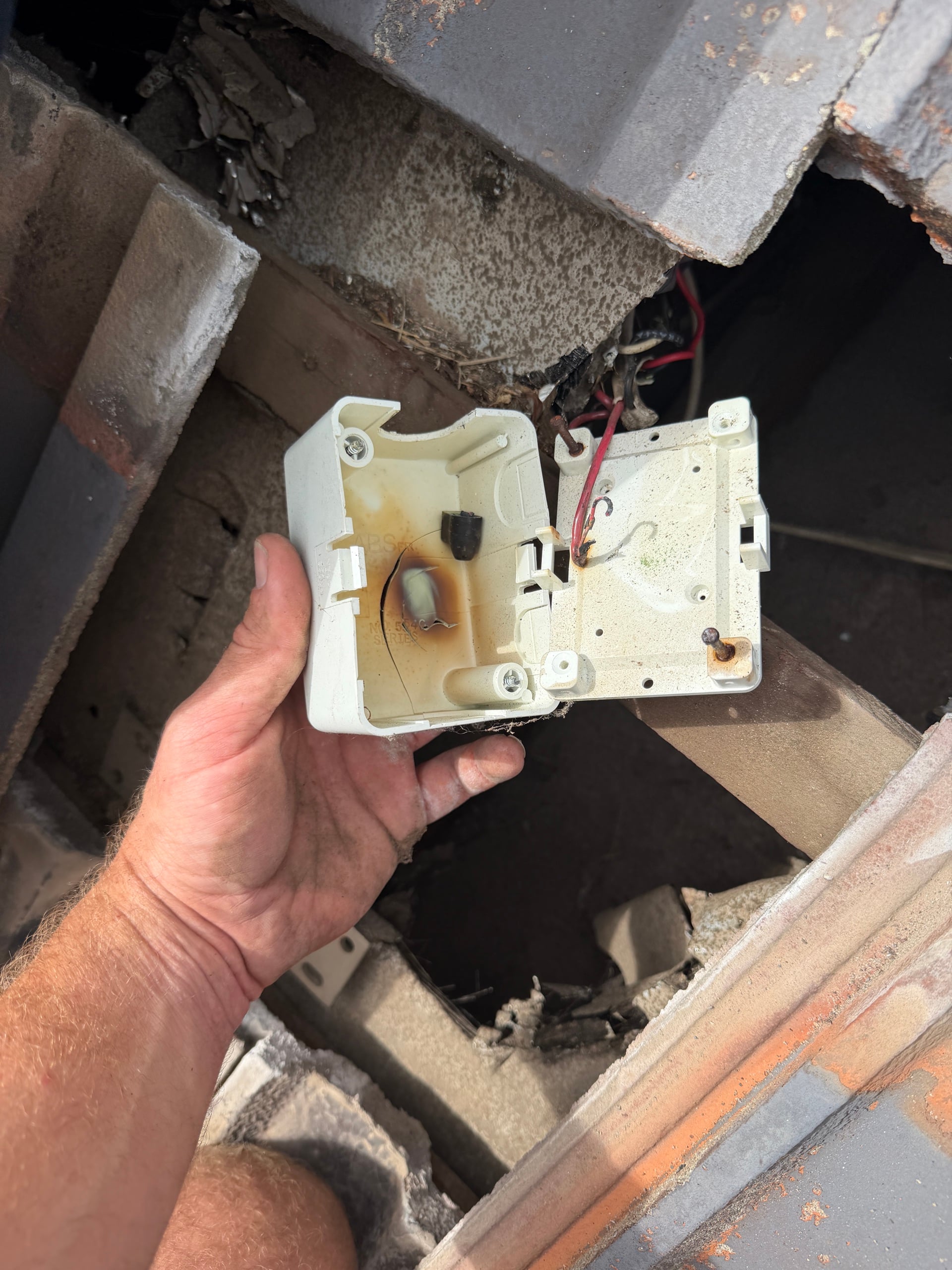 Burnt junction box found in a roof space during an electrical safety inspection in Perth
