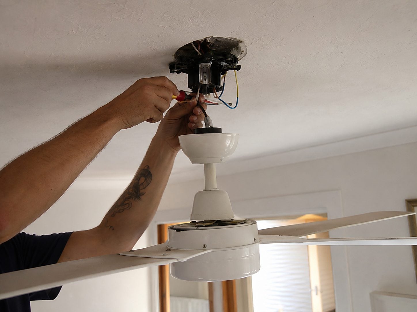 A ceiling fan installed and wired in a Perth home
