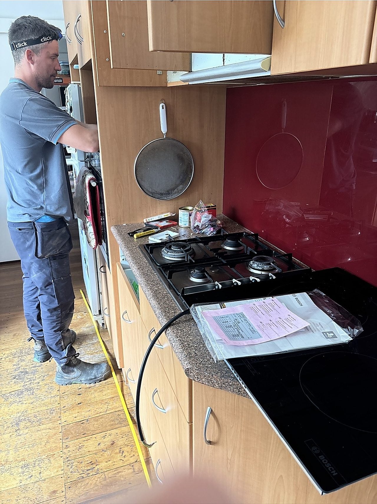 A Riverside gas fitter installing a gas cooktop in a Perth kitchen